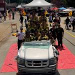 South Whdibey firefighters demonstrate the different ways they can manipulate the vehicle in order to get patients out of the vehicle safely at the Whidbey Island Fair.