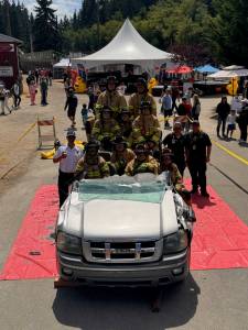 South Whdibey firefighters demonstrate the different ways they can manipulate the vehicle in order to get patients out of the vehicle safely at the Whidbey Island Fair.