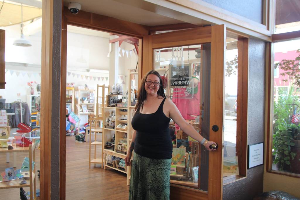 (Photo by Marina Blatt) Kilpatrick holds the shop door open, inviting customers in.