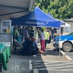 Photo provided
People chat around the community transit booth.