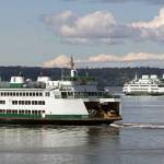 Ferries pass on a crossing between Mukilteo and Whidbey Island in August. (Andy Bronson / Herald file)