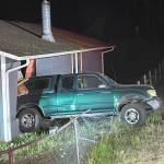 (Photo courtesy of NWFR) A pickup backed into a house on North Whidbey last year.