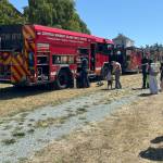 (Photo by Emily Felt) Families admire fire trucks at the Coupeville Library Touch-a-Truck event.