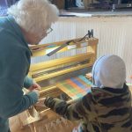 (Photo by Katrina Morse) Learning to weave at A Little Fiber Fest: From Sheep to Cloth event hosted by the Langley library.
