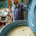 (Photo by David Welton) Distiller John Giardina checks out a bubbling vat of fermenting sheeps whey.