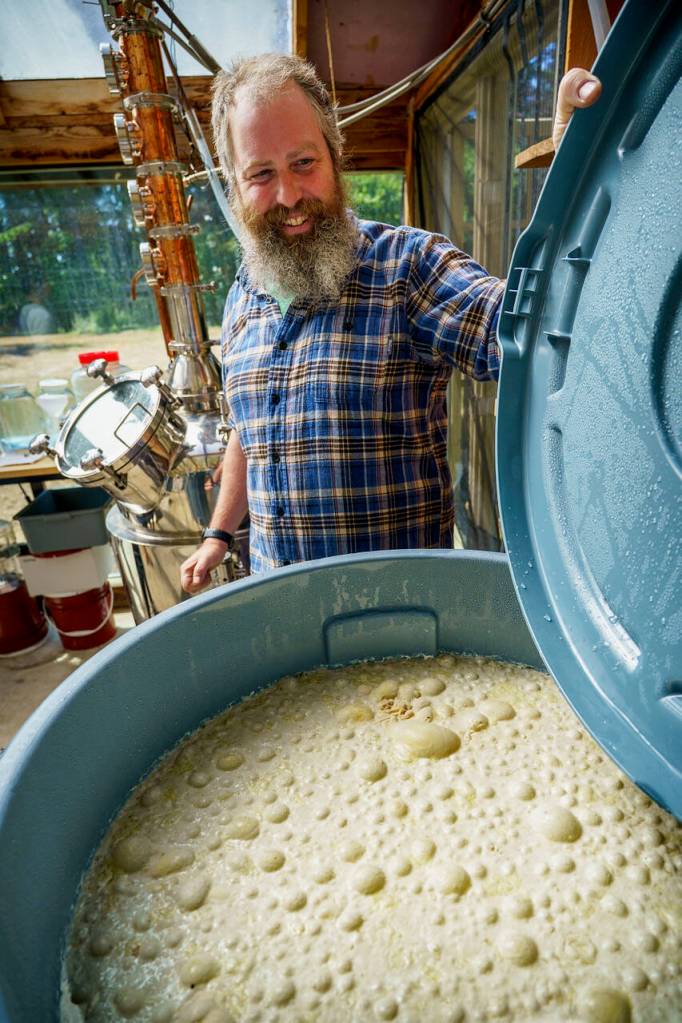 (Photo by David Welton) Distiller John Giardina checks out a bubbling vat of fermenting sheeps whey.