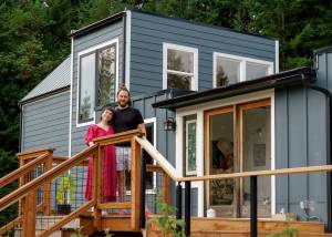 Photo by David Welton
Chanel Jost and Tevon Dubois stand on the front porch of their upcycled home.