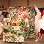 Katie Jones (Chris) poses for her flower calendar girl nude photos. She holds a ring of flowers for modesty.