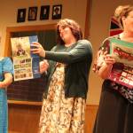 Women admire their nude photos in a Womens Institute calendar. From left are actors Rusty Hendrix (Jessie), Jade Parmenter (Cora) and Katie Jones (Chris). (Photo by Marina Blatt)
