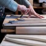 Carol Ann Bauer cuts a shape for a platter at her home in Freeland. (Olivia Vanni / The Herald)