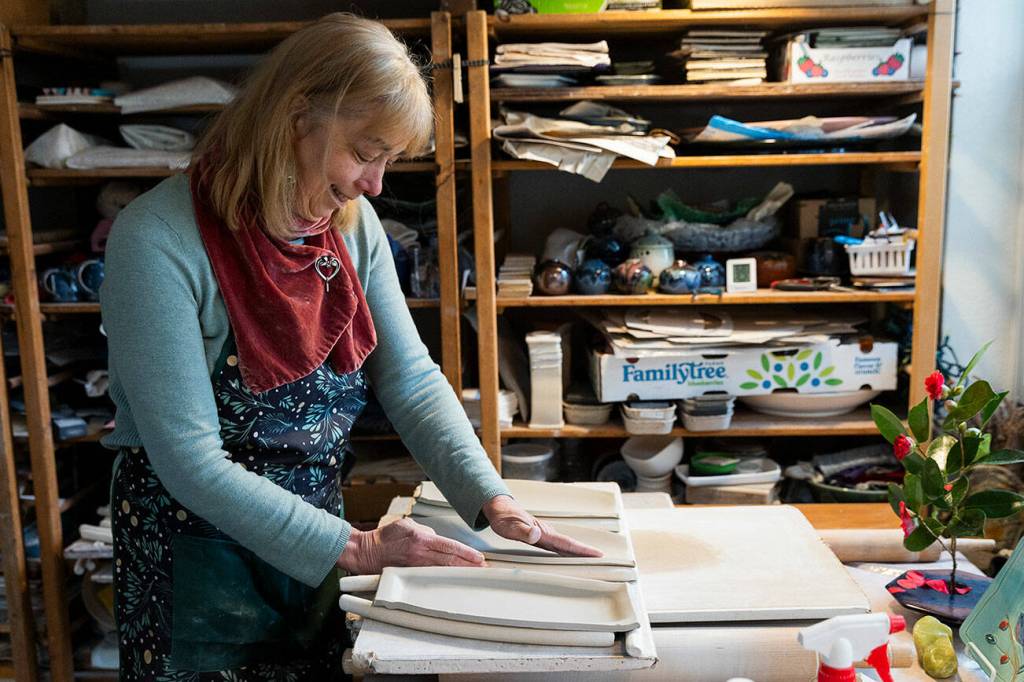 StillFire Pottery’s Carol Ann Bauer forms platters out of clay at her home on Tuesday, March 11, 2025 in Freeland, Washington. (Olivia Vanni / The Herald)