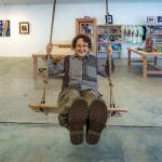 Photo by David Welton
Rocky Jensen, owner of Koneksi Co-Creative Gallery, takes a swinging break in the new, multi-purpose space located in Clinton.