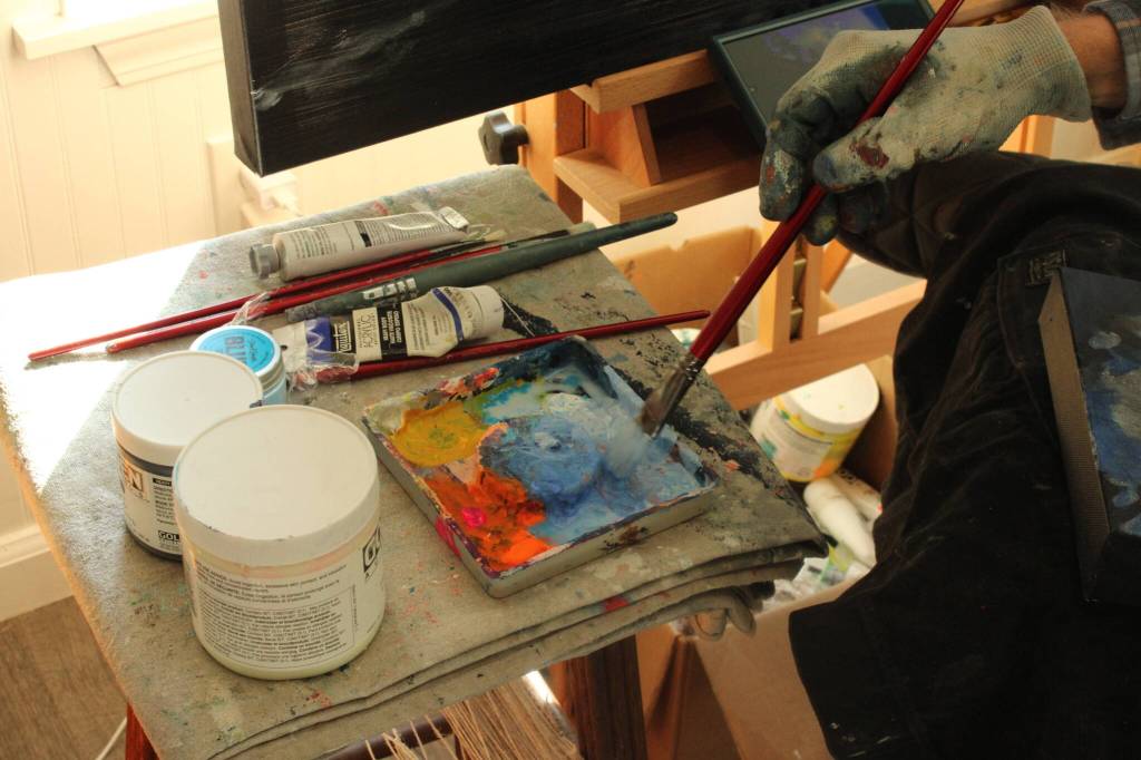 (Photo by Allyson Ballard) Haslet used a small palette and worked slowly, guided by a reference image on his phone.