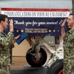 (Photo provided) Nathan Sanchez, right, completes his reenlistment ceremony in front of the Pacific Northwest Naval Air Museums service trainer.