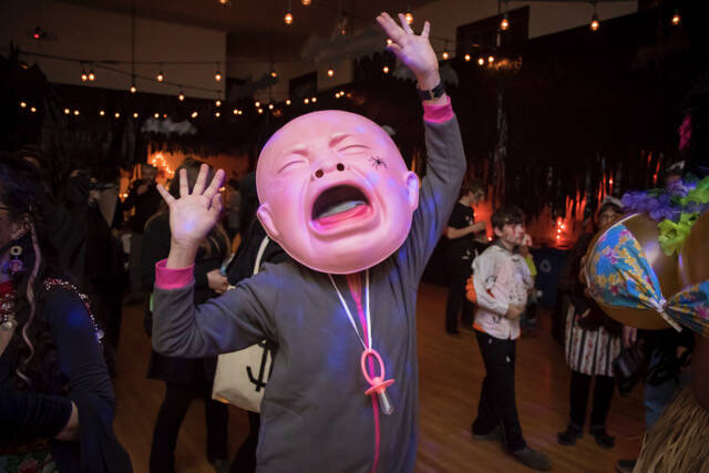 (Photo by David Welton) Creative costumes, such as this giant baby, are a staple of the Black Cat Ball.