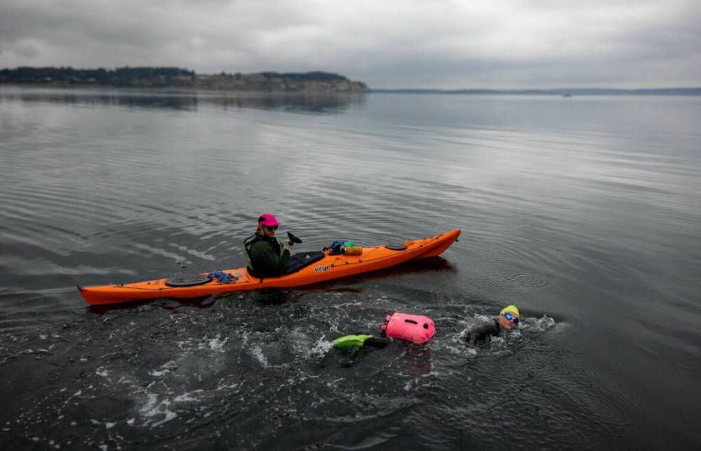 (Photo provided by Sailing with Paul Porter) Nuzzolillo completed her swim flanked by her husband, Evan, and her friend, Paul.