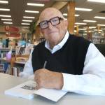 (Photo by Marina Blatt) Douglass Shaw signs a copy of his latest book, Curative Culture.