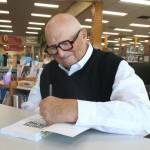 (Photo by Marina Blatt) Douglass Shaw signs a copy of his latest book, Curative Culture.