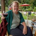 A volunteer sips wine from Spoiled Dog Winery, taking a much-needed break from picking grapes. (Photo by David Welton)
