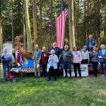 (Photo by Marina Blatt) Members gather in front of the Viking ship at the Whidbey Island Nordic Lodge to dedicate a memorial plaque to its builder, Brian Petersen.