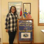 (Photo by Marina Blatt) The Whidbey Island Nordic Lodge President Kathy Smith stands next to nordic flags.