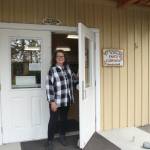 (Photo by Marina Blatt) Smith holds the Whidbey Island Nordic Lodge door open, welcoming visitors inside.