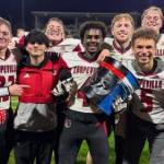 Malachi Somes (holding The Bucket) celebrates a birthday win with his teammates. (Megan Rickner photo)