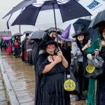The witches congregated at the wharf around 4 p.m. on Saturday to commence the walk. (Photo by David Welton)