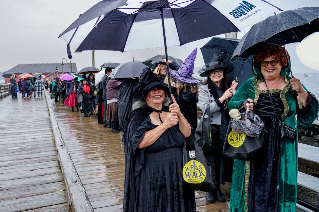 The witches congregated at the wharf around 4 p.m. on Saturday to commence the walk. (Photo by David Welton)