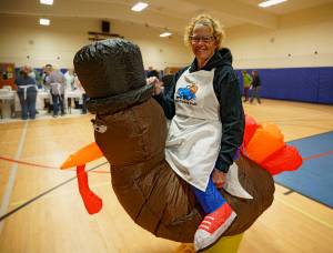 Photo by David Welton
Lana Johnson wears an inflatable turkey costume. As a volunteer last year for Mobile Turkey Unit, she directed traffic into the parking lot for an orderly pick-up of 696 meals.