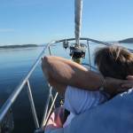(Photo by Marina Blatt) Holderman relaxes at the bow of the boat on a makeshift chair made out of a rolled-up sail