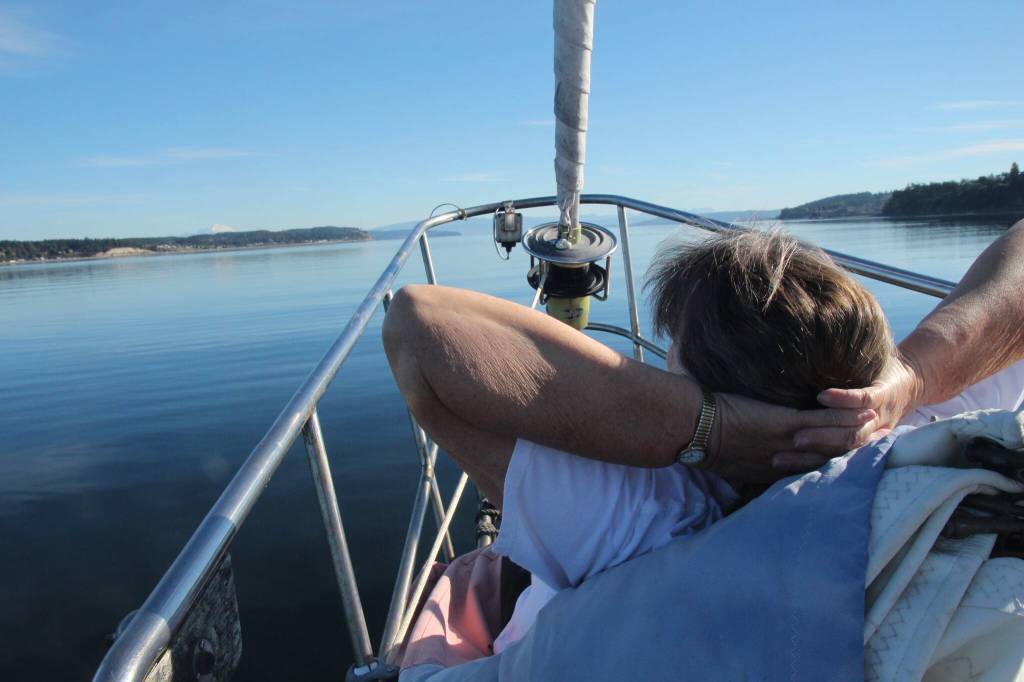 (Photo by Marina Blatt) Holderman relaxes at the bow of the boat on a makeshift chair made out of a rolled-up sail