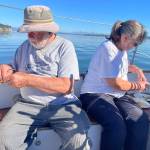 Bill Smith and Carla Holderman feast on crab legs and soak in the sun aboard Bills boat, the Culmination.