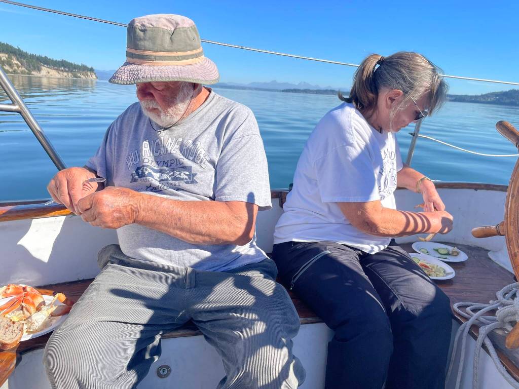 Bill Smith and Carla Holderman feast on crab legs and soak in the sun aboard Bills boat, the Culmination.
