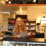 Photo by Marina Blatt
Newbauer greets customers behind the counter of Sweet Monas as she holds up the iconic whale cookie.
