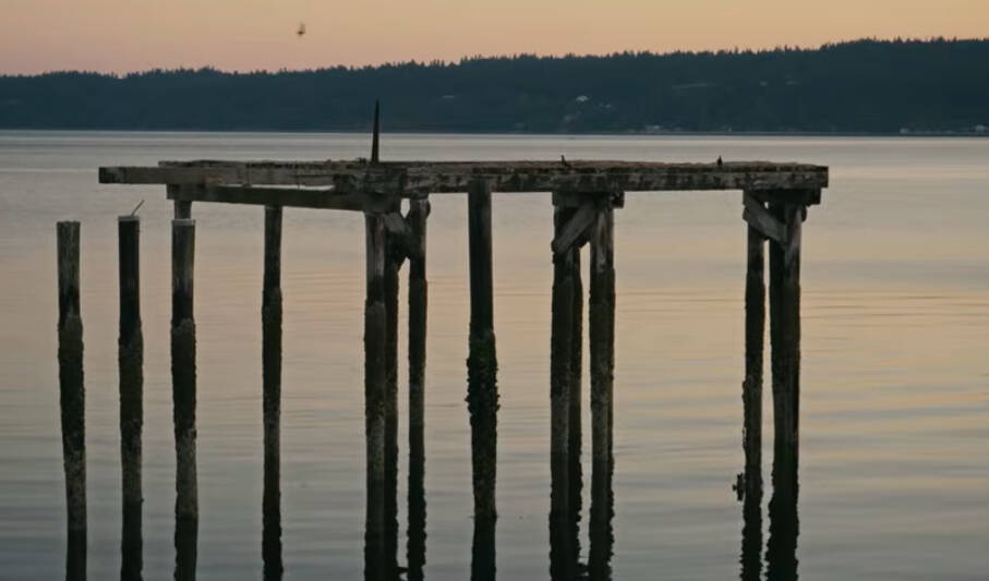 Photo from A War With Time, the acoustic music video on Youtube.
The sun colors the sky behind a pier.