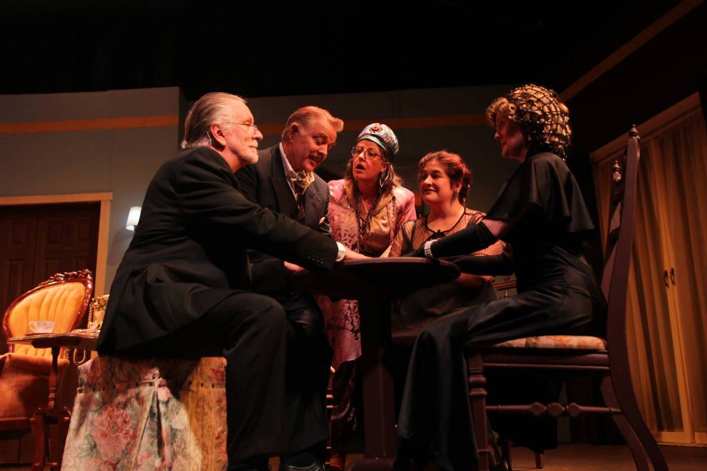 Friends and spouses sit around a table to humor a medium, whom they are very dubious of. From left are Ben Honeycutt (Dr. Bradman), Lachlan Waterbury (Charles), Tiffany Scribner (Madame Arcati), Shealyn Christie (Ruth) and Kellen Cox (Mrs. Bradman). (Photo by Marina Blatt)