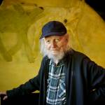 (Photo by David Welton) South Whidbey artist Gaylen Hansen, 104, stands before his painting of wolves. A prolific painter, Hansens works likely number in the thousands.