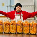 (Photo provided) Sam shows off the ingredients for his small-batch hot sauce.