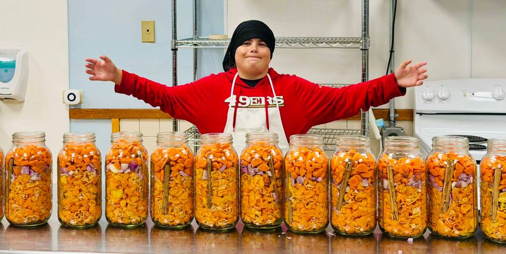 (Photo provided) Sam shows off the ingredients for his small-batch hot sauce.