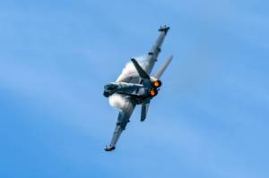 Photo by Joe A. Kunzler
Vapor forms of an EA-18G Growler as it streaks through blue skies.