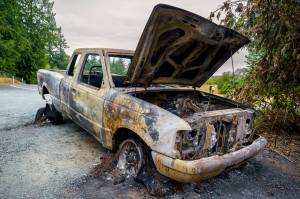 Photo by David Welton
Island County Commissioners are wondering if more can be done to reduce the cost of hauling old and abandoned vehicles, such as this one that suffered catastrophic damage from a fire.