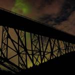 Photo by Randy Heiserman at Deception Pass. The aurora borealis peeps in between the clouds.