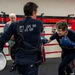 May Sinclaire, Dakota Stones mother, practices punching her body shield. (Photo by David Welton)