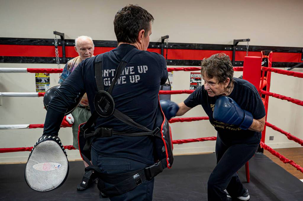 May Sinclaire, Dakota Stones mother, practices punching her body shield. (Photo by David Welton)