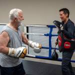 Gary Goltz hits mitts in the ring with Dakota Stones encouragement during a class at Solid Stone Boxing Gym for people with Parkinsons disease. (Photo by David Welton)
