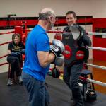 Ron Donovan practices hitting mitts with Dakota Stone. (Photo by David Welton)