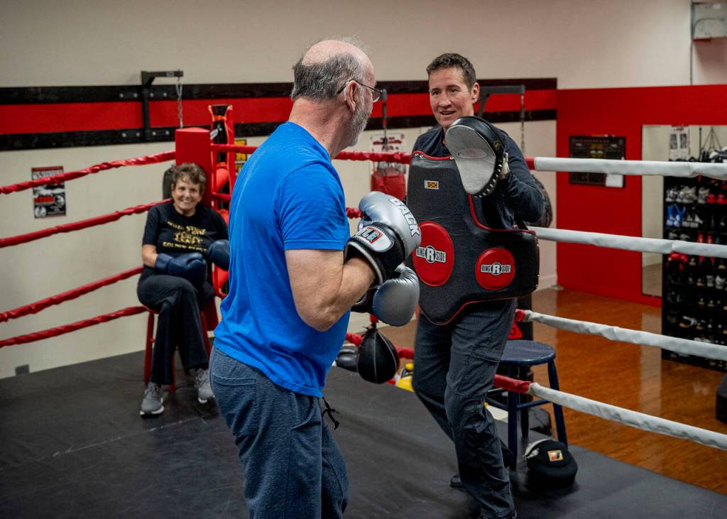 Ron Donovan practices hitting mitts with Dakota Stone. (Photo by David Welton)