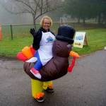 Lana Johnson greets community members in a turkey suit for the Mobile Turkey Unit. (Photo by David Welton)