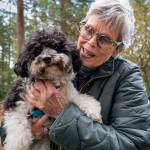 (Photo by David Welton) Jan Naud cuddles with Domino, her miniature poodle.